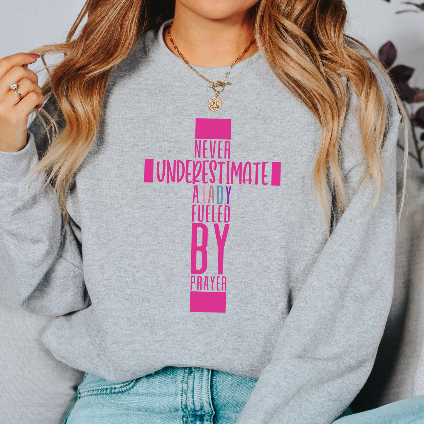 NEVER UNDERESTIMATE UNISEX SWEATSHIRT